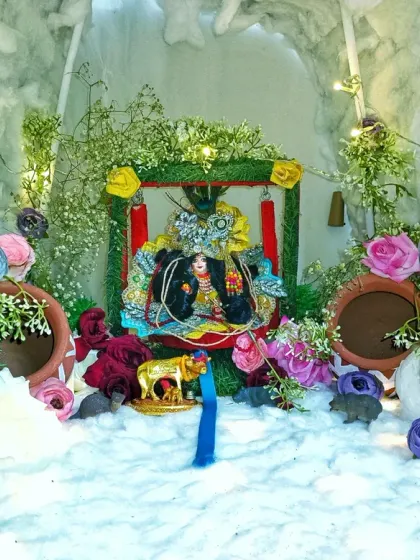 This is a detailed Janmashtami jhanki I made. The small diorama for Bal Gopal is set in a cave-like structure, decorated with greenery, flowers, and tiny matkas to depict scenes from Krishna's life.