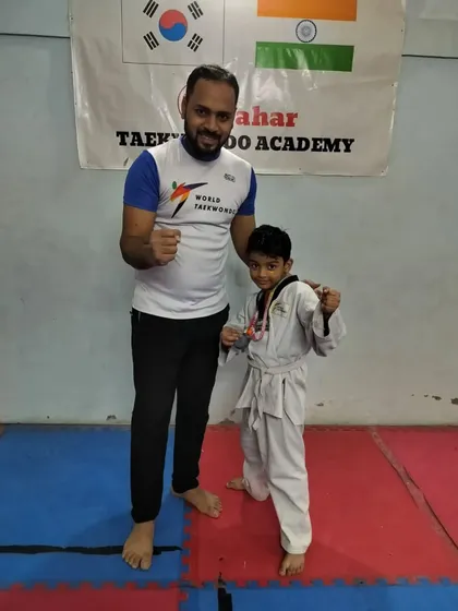 A young white belt showing great promise with his first medal.