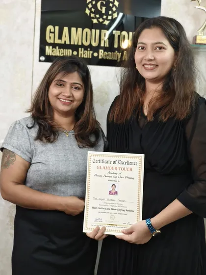 One more student receives her certificate for completing the Hair Cutting and Blow Drying course. Her smile says it all.