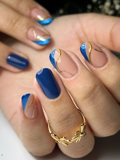 Another angle of the ink blue cat eye French manicure, showing how the light catches the glitter and chrome details. This design is perfect for clients seeking a unique and elegant style.