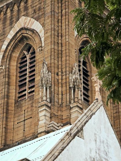 A closer look at the detailed stonework and arched windows of a historic church.