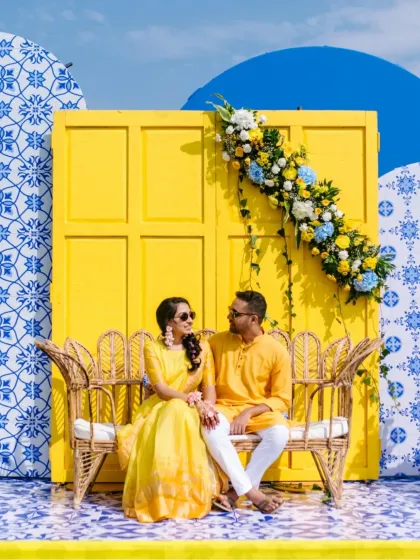 A vibrant Haldi ceremony set against a stunning blue and yellow backdrop in Goa. This shot showcases how I capture the essence of a colorful and lively destination wedding.