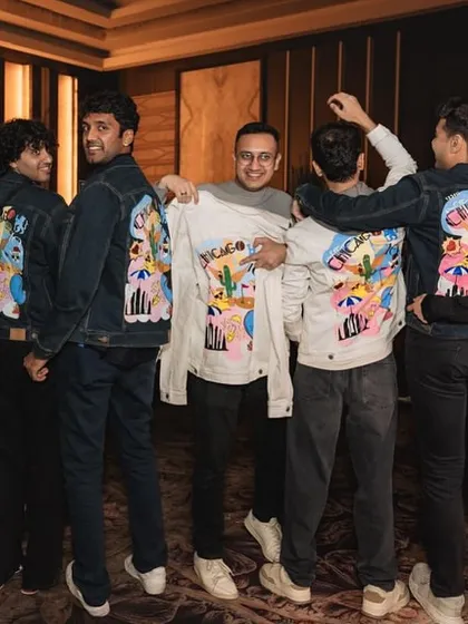 The groom and his friends showing off their custom-designed wedding jackets. Such a cool and personal touch for their big day.