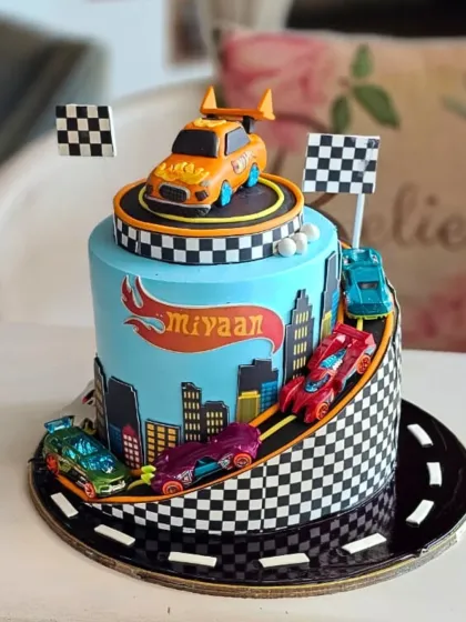 Ready, set, go! This dynamic Hot Wheels cake brings the racetrack to the party with a winding road, checkered flags, and a collection of colorful cars. It's a high-energy design perfect for a young racing enthusiast's birthday.