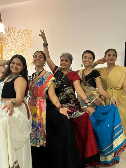 Five of us striking a pose during the Navratri festivities. The joy and energy of dancing together is something we look forward to all year.