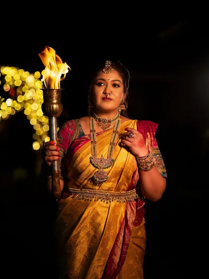 Another powerful image from the "Navataar" series, with the torch illuminating the subject's determined expression against a backdrop of bokeh lights.