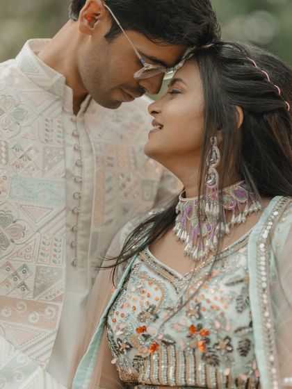 A quiet, intimate moment with the couple touching foreheads. This pose is perfect for capturing the deep, unspoken bond between them.