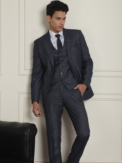 A full view of the navy blue three-piece suit. We have been in the business of tailoring for over 140 years and offer the widest variety.