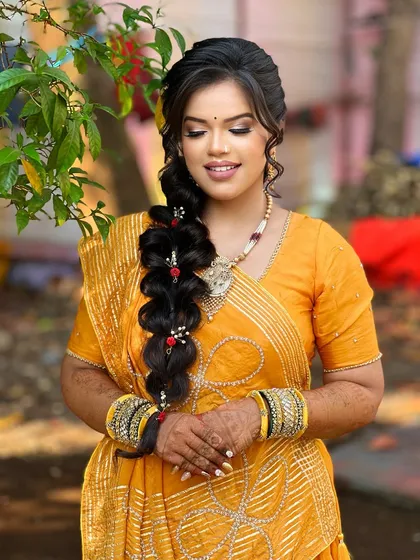 A close-up of the beautiful braid and the soft, natural-looking makeup.