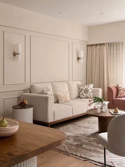 This shot from "Apartment 222" shows the clean lines of the sofa and the classic elegance of the wall paneling. The space is designed to feel uncluttered and serene, a perfect example of refined minimal design.