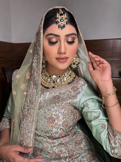 The complete look, with the dupatta elegantly framing her face. This subtle bridal makeup is perfect for daytime ceremonies.