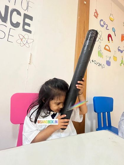 This little one is fascinated by the rainbow she's discovered. It's a magical way to introduce the science of light and optics to young, curious minds.