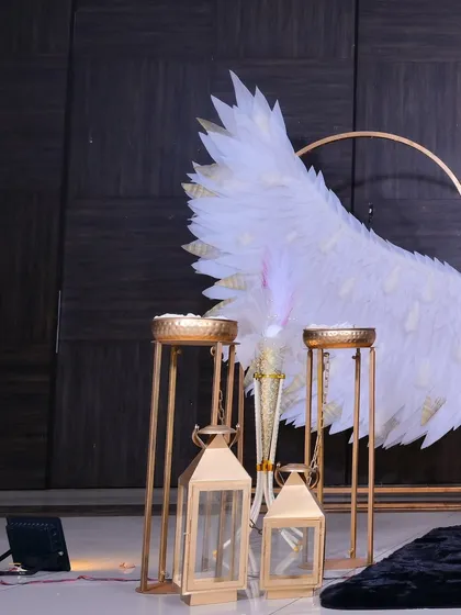 A close-up of the decorative details, including golden lanterns and candle stands that add a warm and elegant glow to the baptism setup.