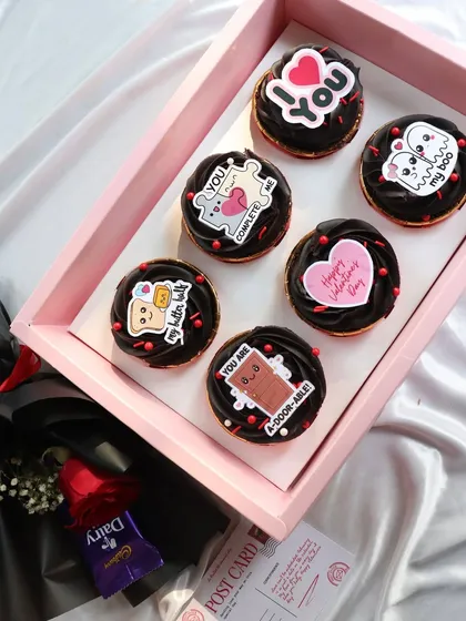 The perfect gift set, featuring the 'Love Notes' cupcakes, a postcard, and a flower bouquet.
