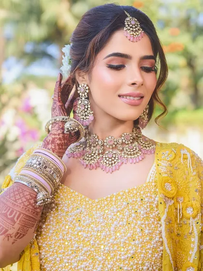 A close-up on the Haldi makeup. The soft pink eyeshadow and radiant skin create a fresh and youthful look.