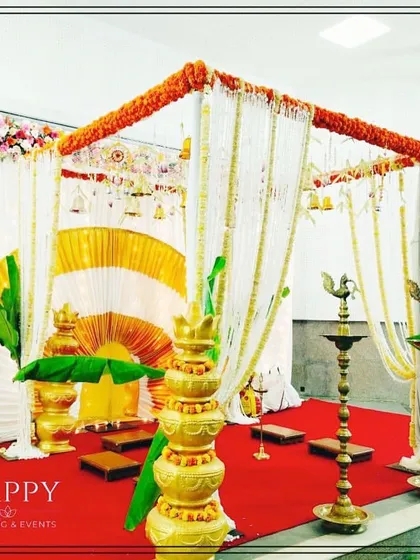A classic South Indian mandap designed with reverence for tradition. The setup features sacred banana leaves, elegant white and gold drapes, hanging bells, and traditional brass oil lamps (diyas) to create an authentic and blessed space for your wedding rituals.
