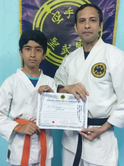 A young practitioner is awarded his 7th Kyu (orange belt). His enthusiasm and hard work are a pleasure to see in the dojo.