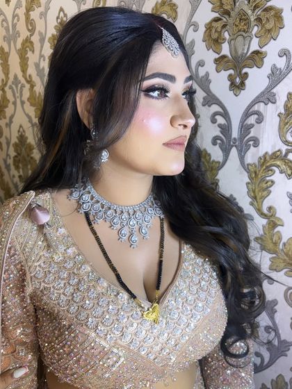 A side profile of the reception look, highlighting the soft contouring and the beautiful open hairstyle with gentle waves.