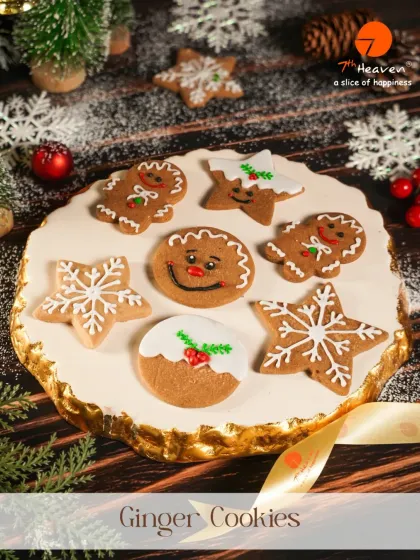 A platter of our hand-decorated ginger cookies. These festive treats come in various shapes like gingerbread men, snowflakes, and stars, perfect for sharing.