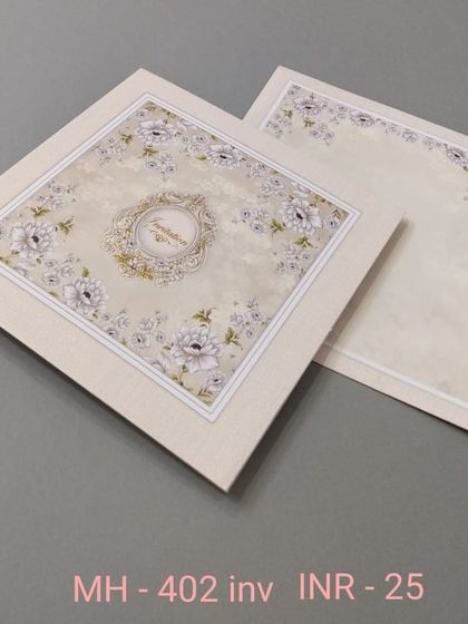 An affordable and elegant invitation with a white-on-white floral pattern. The central monogram adds a touch of personalization to this classic design.