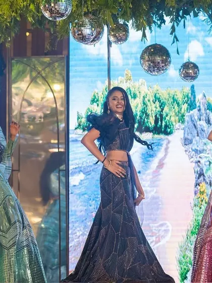 The bride with her sister and sister-in-law, the "Radhas on the dance floor". A beautiful still from a vibrant and colorful sangeet performance.