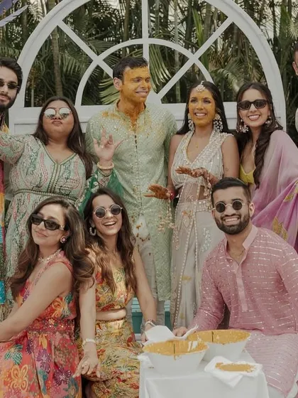 The couple posing with their closest friends. The Haldi ceremony is a great opportunity for fun and memorable group pictures.