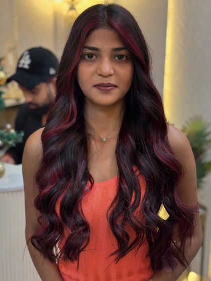 A full view of the red wine hair colour, showcasing how it complements her skin tone and creates a bold, confident look.