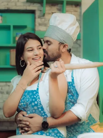 Love is cooking up something beautiful! This couple shares a laugh in a quirky kitchen setting, a perfect example of a themed pre-wedding shoot that reflects shared interests and creates fun, natural interactions.