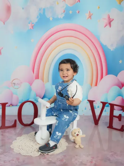A cool dude on his tricycle, surrounded by "LOVE" blocks and a pastel rainbow, making for a vibrant and joyful birthday portrait.
