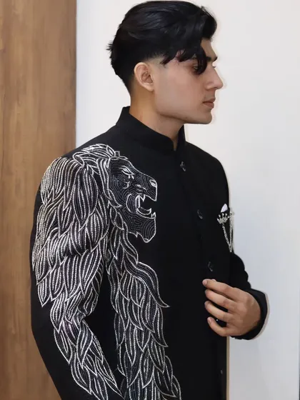 A full view of the lion-embroidered Jodhpuri jacket. The design is strategically placed on one shoulder and sleeve, creating a unique and dynamic look.