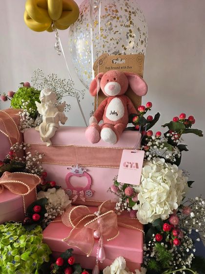 Another view of the pretty pink hamper with a plush bunny.