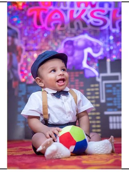 Another happy moment from the superhero-themed session, capturing the child's excitement and wonder.
