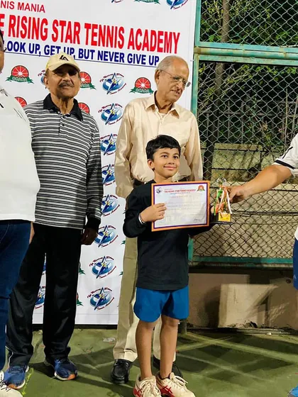 Our little champ Aariv adds another trophy to his collection. This photo captures him receiving his prize at a Rising Star Tennis Academy tournament, proving our players are competitive everywhere they go.
