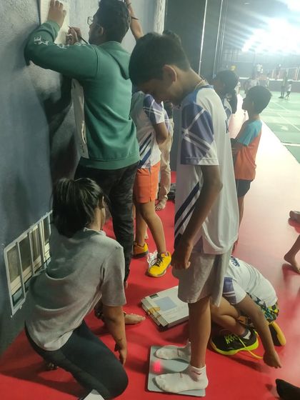 The team working together to conduct routine height and weight assessments for all the young athletes at the academy.