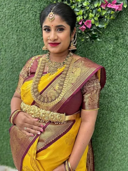 Our gorgeous mom-to-be Deepika Reddy in a stunning yellow and brown Kanchipuram silk saree. The warmth of the yellow exudes the sunshine of her happiness.