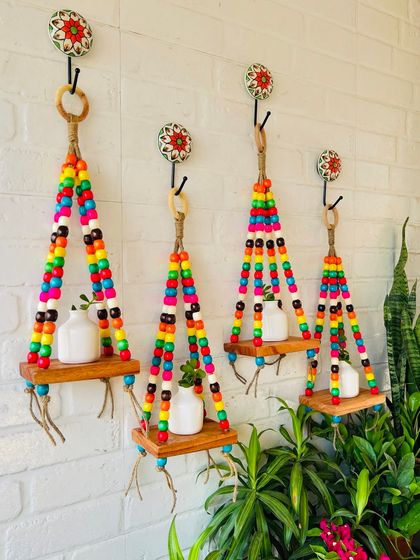 These colorful beaded wall shelves are one of our bestsellers. They are made with jute twine and natural wood shelves, perfect for small plants.