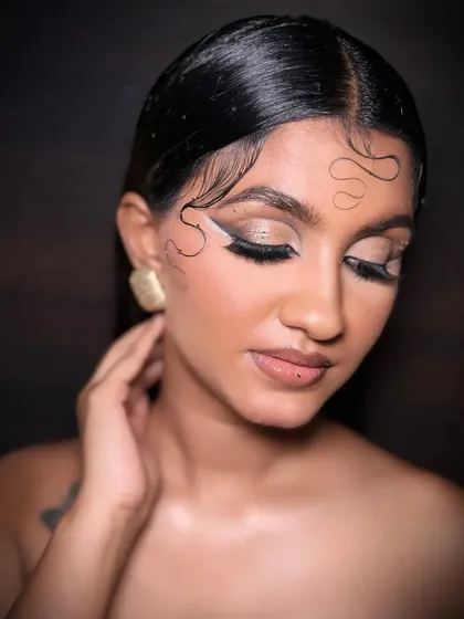 This pose highlights the sculpted cheekbones and the seamless blend of the airbrush foundation, achieving a flawless finish that's essential for editorial photography.