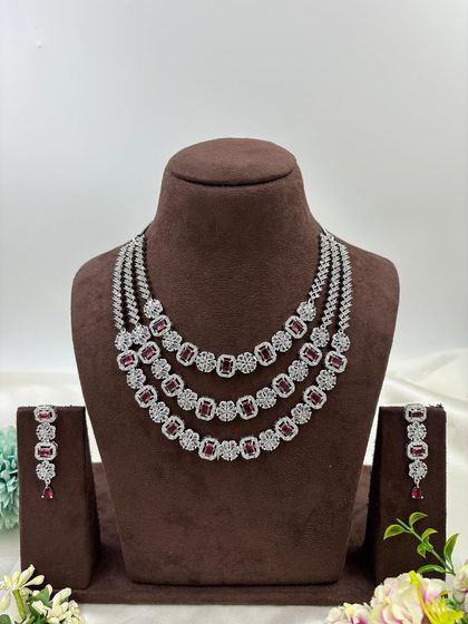 A three-row AD necklace set with square-cut stones. This classic and elegant design is available in all-white, mint green, ruby, blue, and a multi-color option.