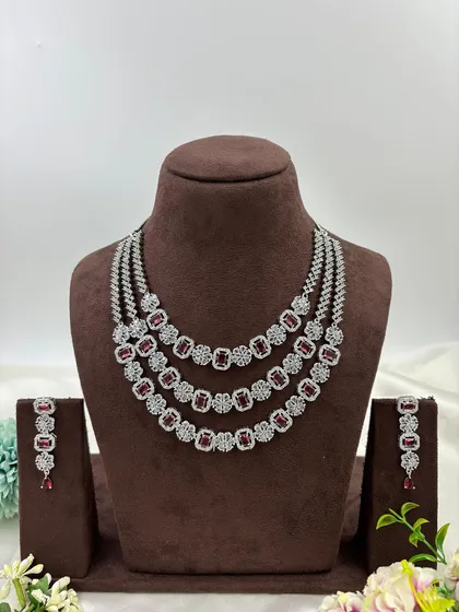 The three-layer AD necklace with red stones.
