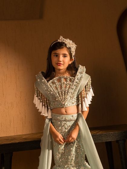 A close up of the stunning, hand embellished fan detail on the blouse of this mermaid lehenga.