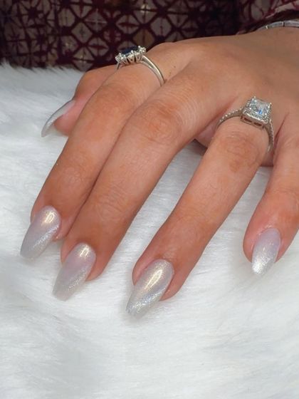 A simple yet elegant silver cat eye effect on long, coffin-shaped nails.