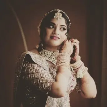 Another angle of the bride getting ready. Her hair is styled to be both beautiful and functional, holding the weight of her veil securely.
