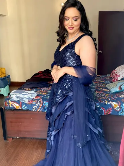 A beautiful party makeup look in a navy blue gown. The makeup is soft and glamorous, with a focus on the eyes.