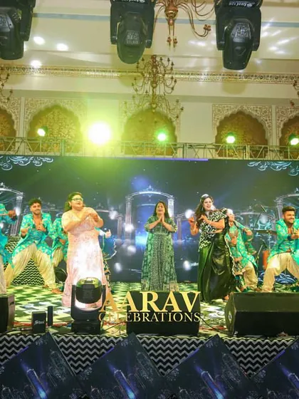 A big family group performance on stage. I love choreographing these large numbers, ensuring everyone is synchronized and the stage is filled with joyous, coordinated energy.