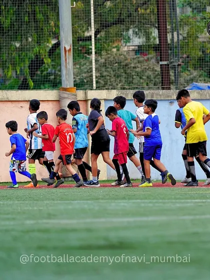 A group of players jogging as part of their warm-up routine, building endurance and preparing for the session.