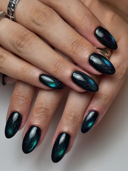 The full set of the deep blue-green galaxy cat-eye nails. This look is dark, mysterious, and incredibly eye-catching.