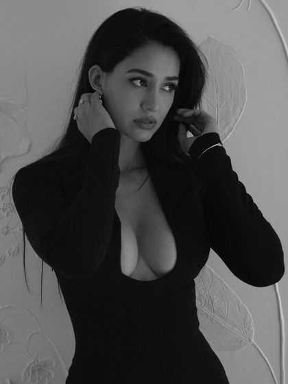 A black and white still of Disha Patani from the music video 'Gustaakh Ishq'. I did both hair and makeup for this shoot, creating a sultry and dramatic look.