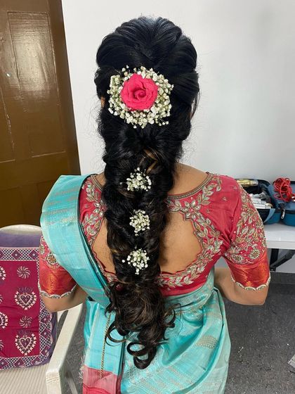 I created this textured messy braid and adorned it with baby's breath and a fresh pink rose, a beautiful combination for an engagement hairstyle.