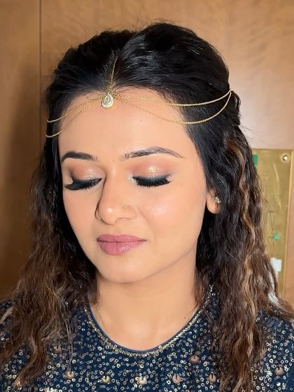 Another close-up of the eye makeup, showing the blend of soft shimmer and liner. The lashes are full and fluttery, completing the dramatic effect.