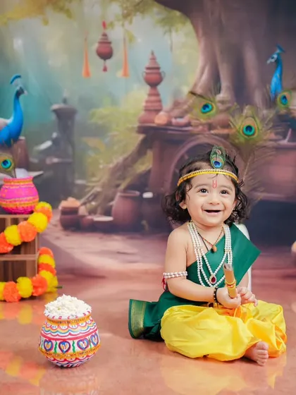 The pure joy of being little Krishna. This shot captures a beautiful, spontaneous smile that makes the entire session worthwhile.